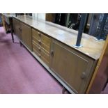 Teak Sideboard, with three central drawers, cupboard doors, on circular legs.