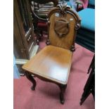 XIX Century Mahogany Hall Chair, with fleur de lys cresting, carved shield to solid back on cabriole