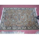A Machine Woven Rug in the Persian Style, the gold field with an allover design of flowers and