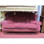 A Three Seater Settee, upholstered in a wine coloured damask, on gadrooned and reeded feet.