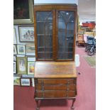 A 1920's Walnut Bureau Bookcase, astragal glazed doors with adjustable shelving, over fall front and