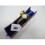 An 18ct Gold Cased Ladies Wristwatch, with half hunter style case, the white enamel dial with