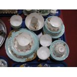 A Limoges Part China Tea Service, printed floral swags on a powder blue border, comprising ten cups,