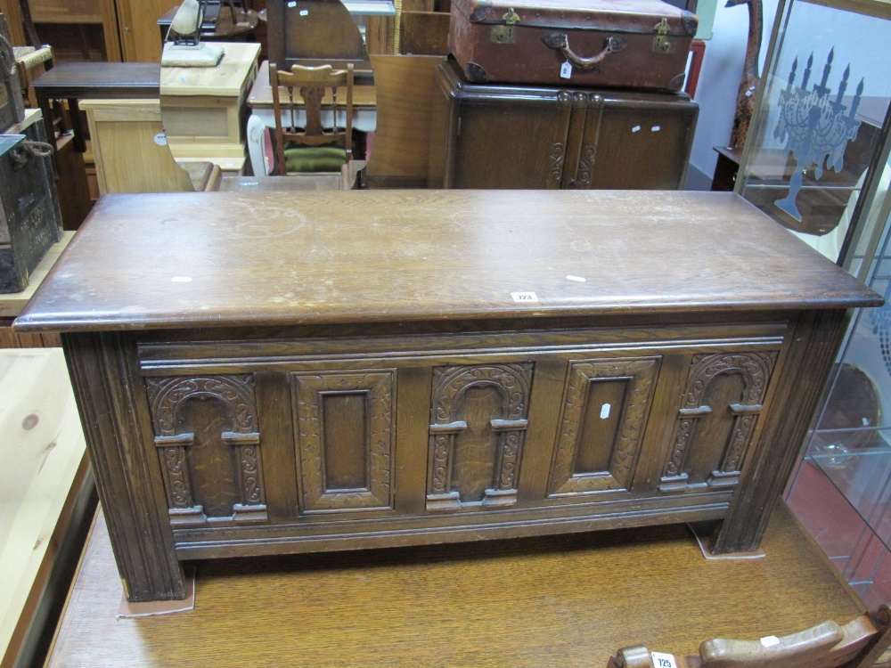 An "Old Charm" Oak Blanket Box, plain hinged top over triple arched carved panels, each with "S"