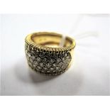 An 18ct Gold Diamond Set Dress Ring, the wide band set to the front with uniform brilliant cut