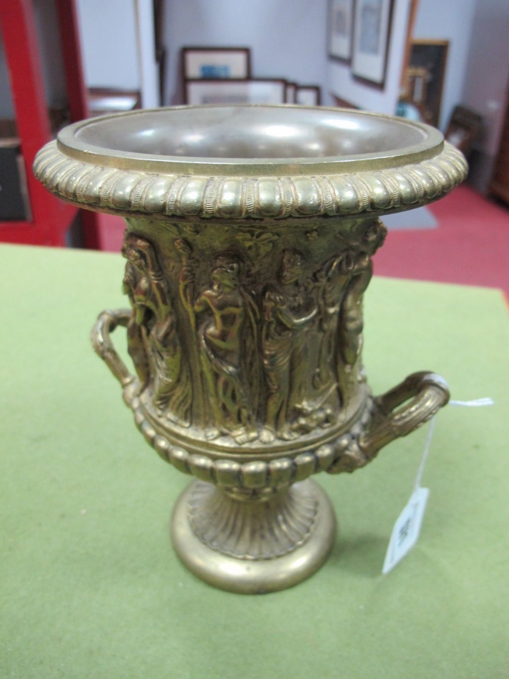 A XIX Century Brass Twin Handled Urn, cast decoration of a frieze of classical figures dancing and