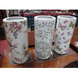 Three Ceramic Original Stick Stands, of cylindrical form decorated with butterflies and foliage.