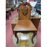 XIX Century Mahogany Hall Chair, with fleur de lys cresting, carved shield to solid back on cabriole