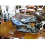 A Novelty Oval Glass Topped Coffee Table, the resin base moulded with three dolphins, two with