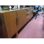A 1970's Teak Sideboard, central back of three short drawers flanked by twin cupboard doors,