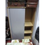 A Modern office Cupboard, plastic tambour front shutter with adjustable shelving.