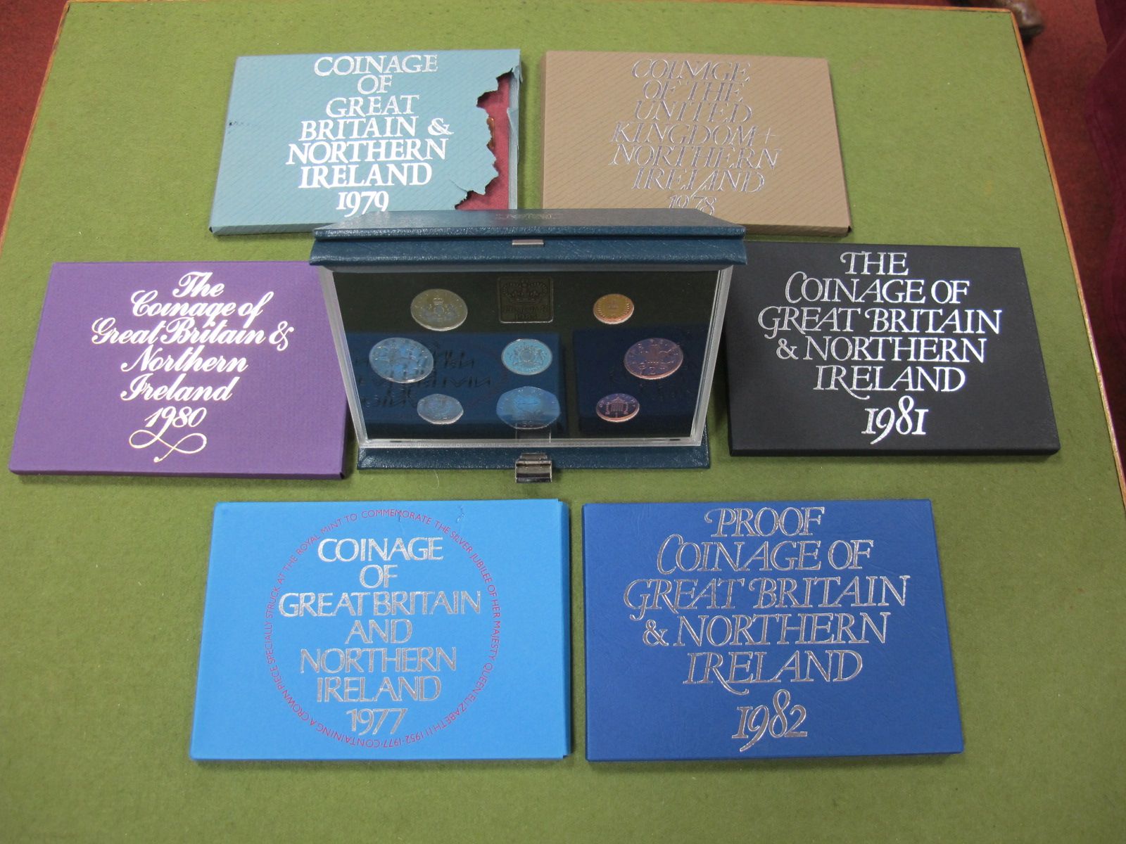 Seven Royal Mint Proof Sets: 1977 (plastic case cracked and outer envelope holes), 1978, 1979 (outer