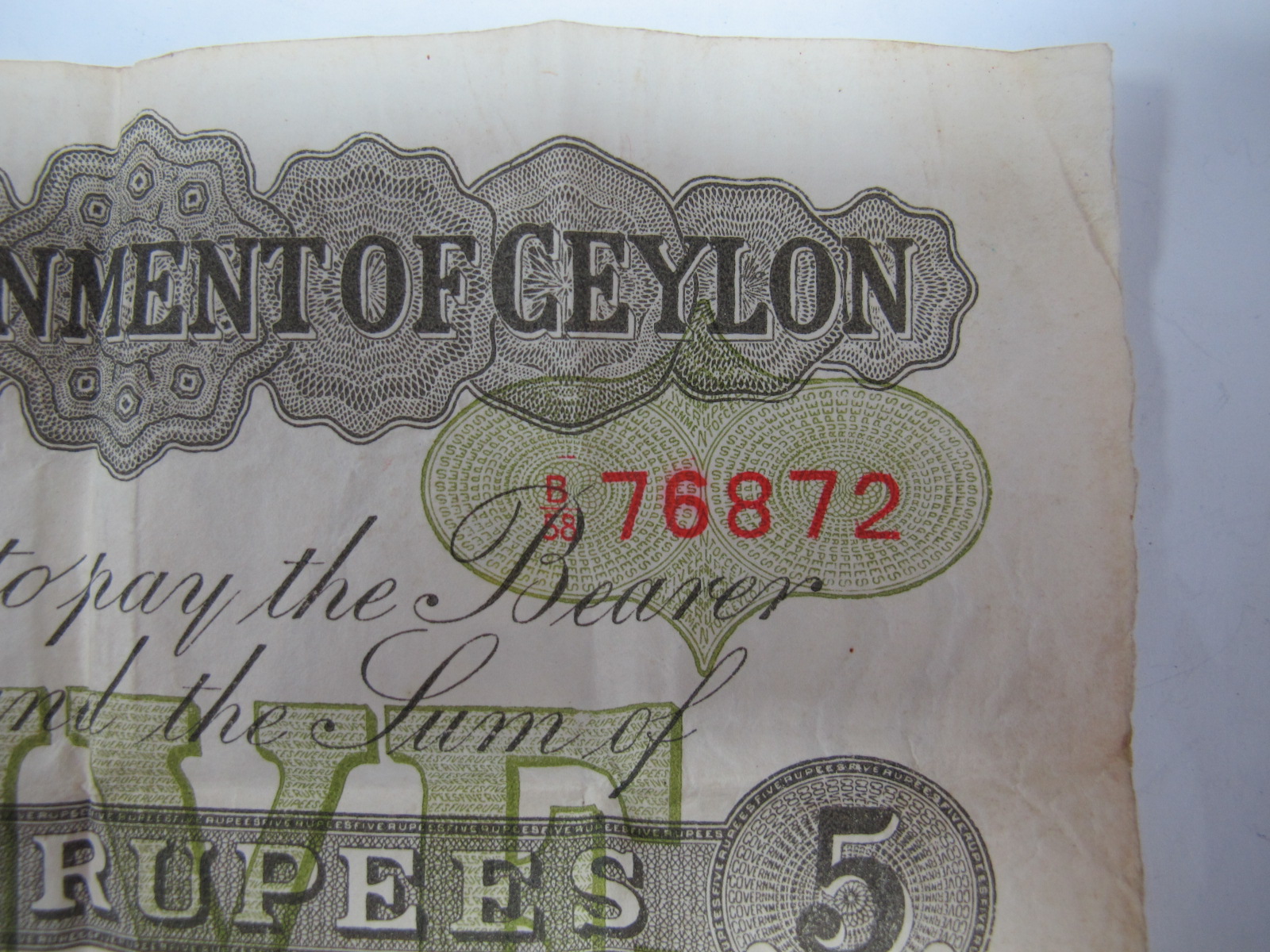 A Government of Ceylon Five Rupee Banknote, Colombo, 1st October 1925. Number B58 76872. Much folded - Image 5 of 7