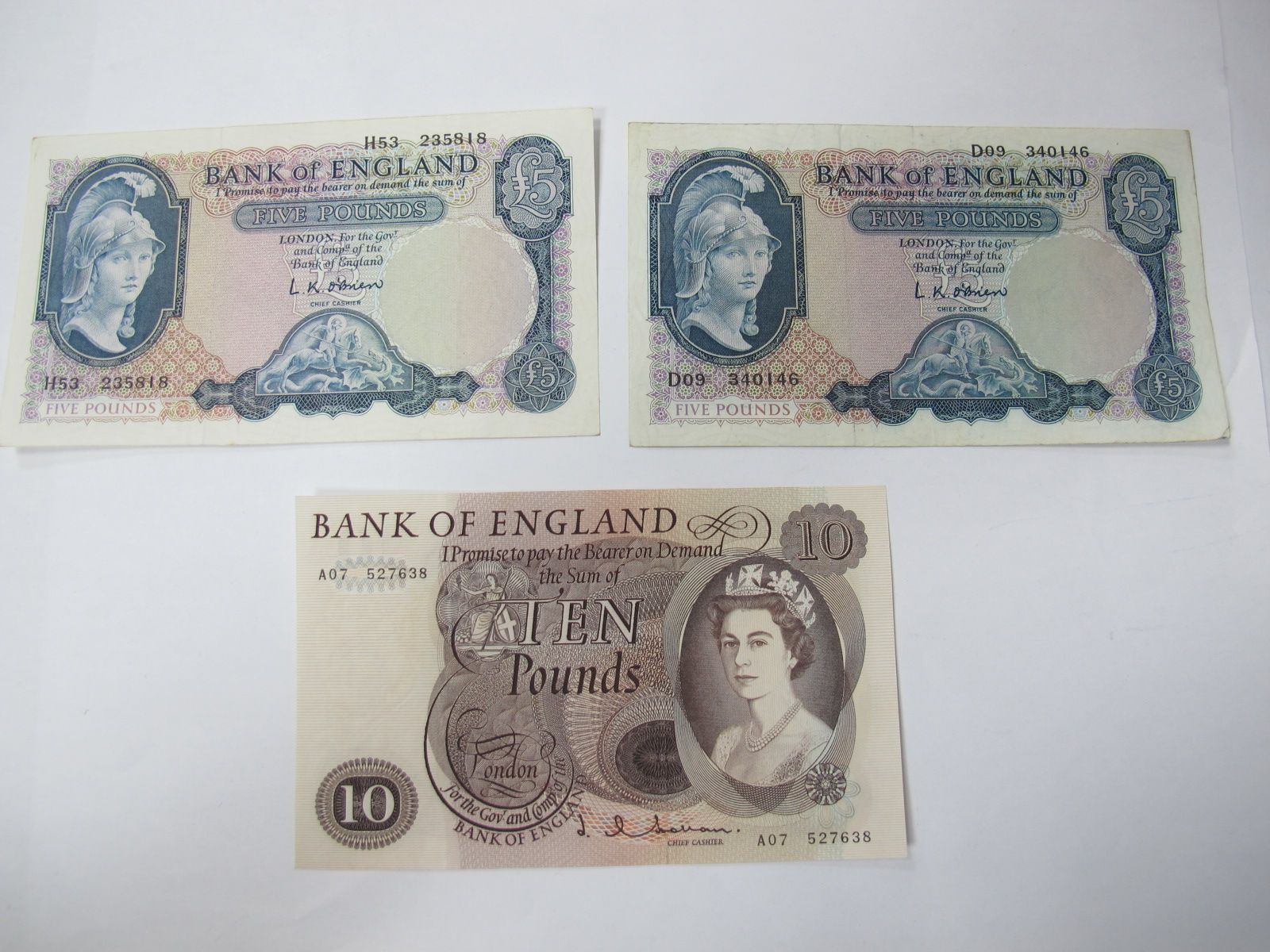 Bank of England Banknotes, comprising a Hollom Ten Pounds and a pair of O.Brien 'Helmeted Britannia'