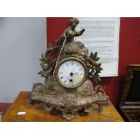 XIX Century French gilt Mantel Clock, of a female on top of clock dial, with foliage, enamel