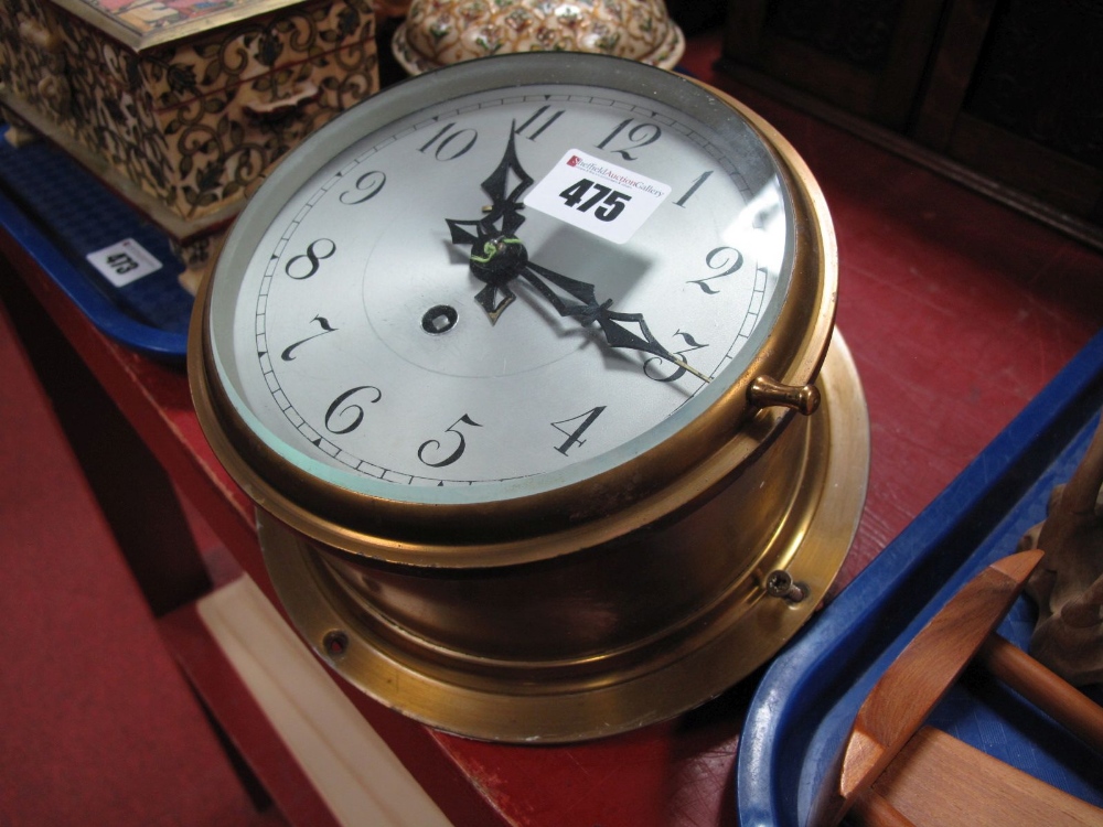 A Brass Cased Ship's Clock, silvered dial Arabic numerals, 6" diameter dial.