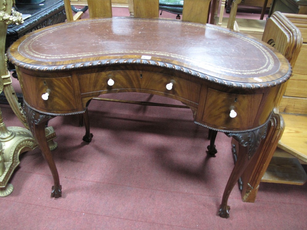 XX Century Mahogany Kidney Shaped Writing Desk, with a cross banded top, leather sciver, gadrooned