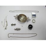 A Hallmarked Silver Tea Strainer, with twin scroll slide handles; together with chains,