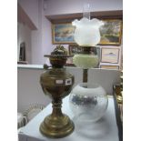 Early XX Century Brass Oil Lamp, with yellow tinted glass well on black glaze circular base, another