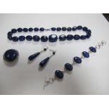 A Modern Lapis Lazuli Bead Necklace, together with a bracelet, oval collet set, a pair of drop