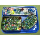 Four Boxes of Marbles, including large examples (a large quantity):- One Tray