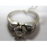 A Single Stone Diamond Ring, the brilliant cut stone slaw set high between four princess cut