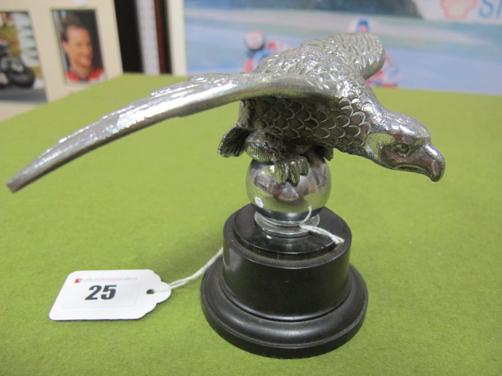 A White Metal Car Bonnet Mascot in the style of an Eagle, mounted on a circular plinth, by Desmo.