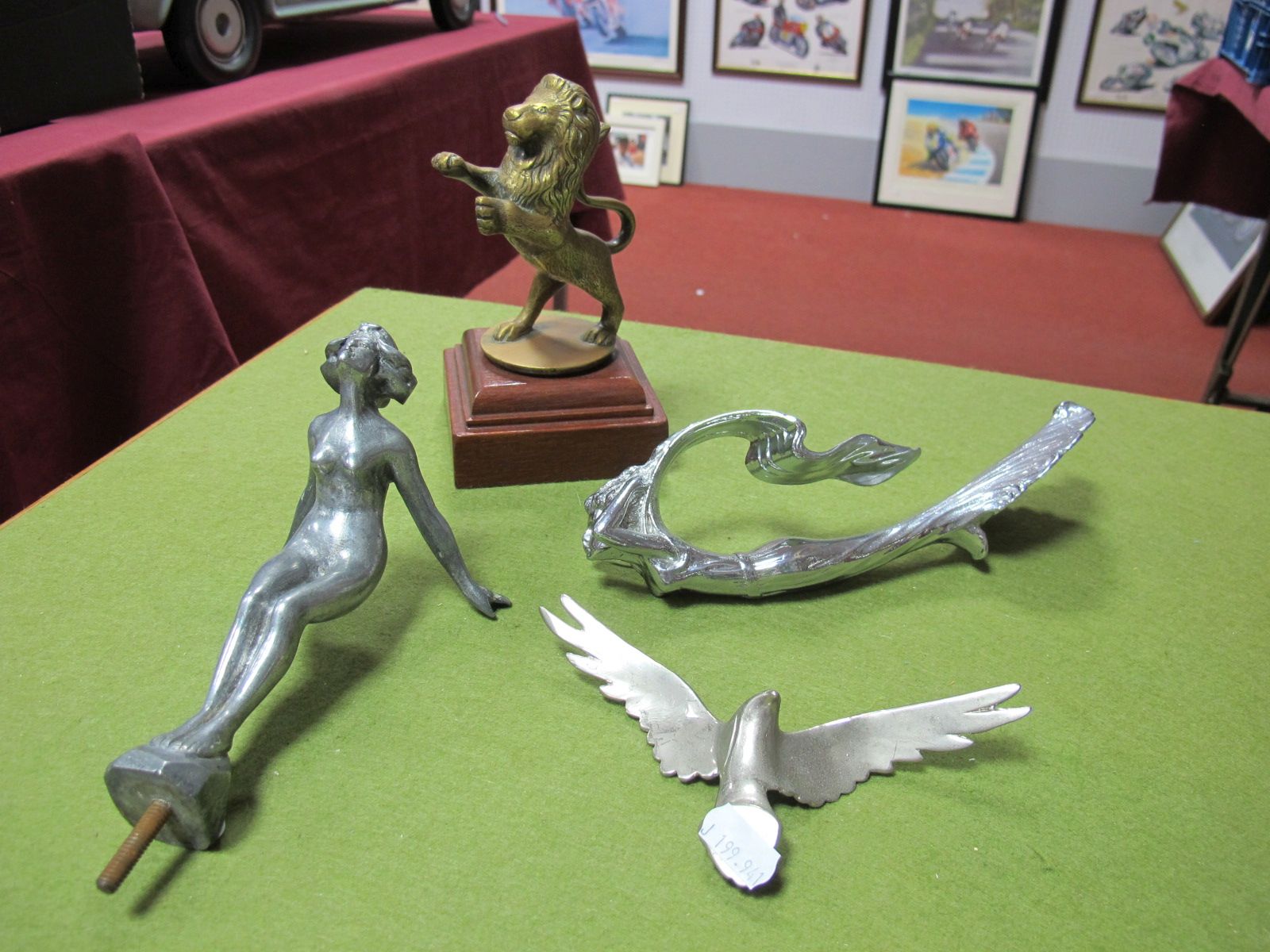 Four Car Mascots; White Metal Naked Lady, White Metal Mermaid, White Metal Bird of Prey, Brass