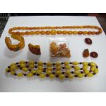 A Single Strand Graduated Amber Bead Necklace, together with a yellow glass bead necklace, a brooch,