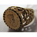 A Gent's 9ct Gold Ring, as a coin between textured pierced shoulders.