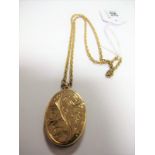 A 9ct Gold Oval Locket Pendant, leaf scroll engraved, on a chain.