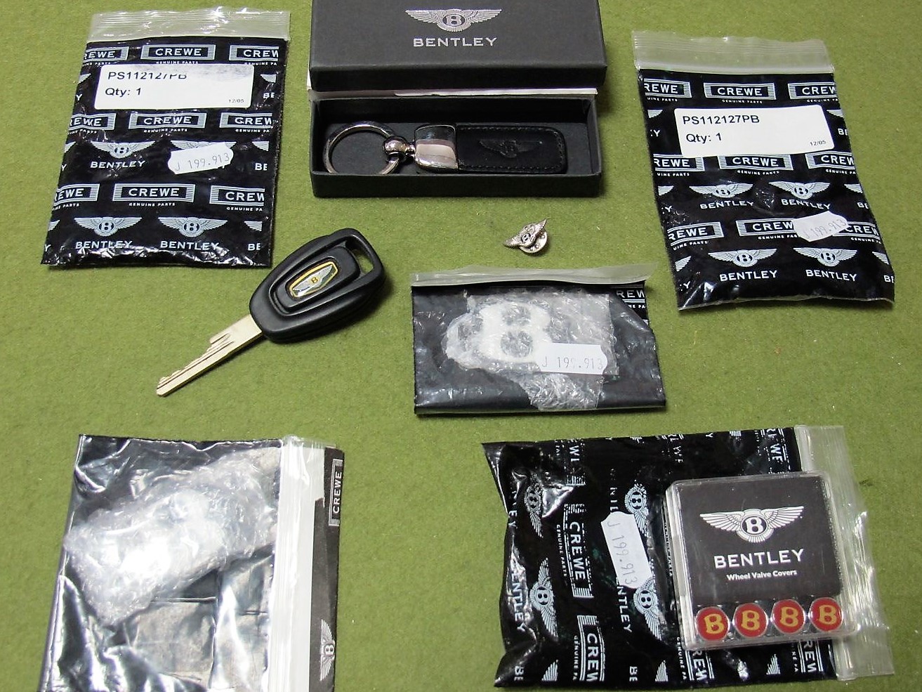 Bentley Genuine Parts, valve dust caps red, leather cap keyring black, two black B badges and