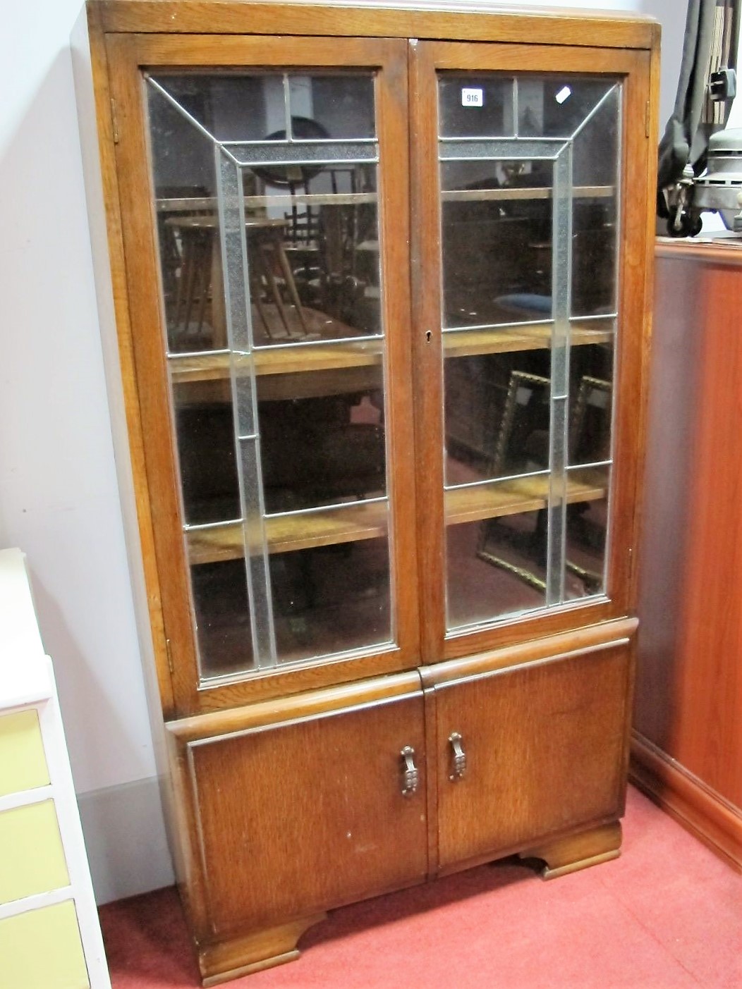 1920's Oak Bookcase, with leaded glazed doors, over cupboard doors, bracket feet.