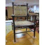 A Circa XIX Century Arts and Crafts Open Arm Chair, the upholstered back supports with carved