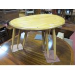 An Ercol Nest of Three Light Elm Pebble Top Tables, on splayed spindle legs.