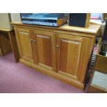 A Cabinet, with low shaped back, three panelled cupboard doors, plinth base.