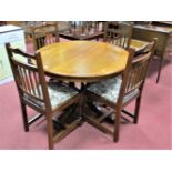 A Modern Oak Draw Leaf Dining Table, circular top with concealed leaf, on four turned column