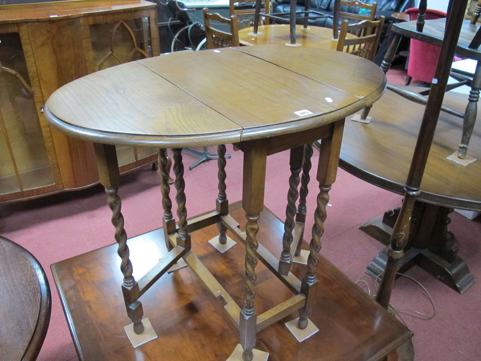 1920's Oak Drop Leaf Table, with a oval top, moulded edge on barley twist legs, united by