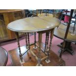 1920's Oak Drop Leaf Table, with a oval top, moulded edge on barley twist legs, united by