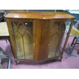 A Mid XX Walnut China Cabinet, with bow front centre panel, raised on squat cabriole legs