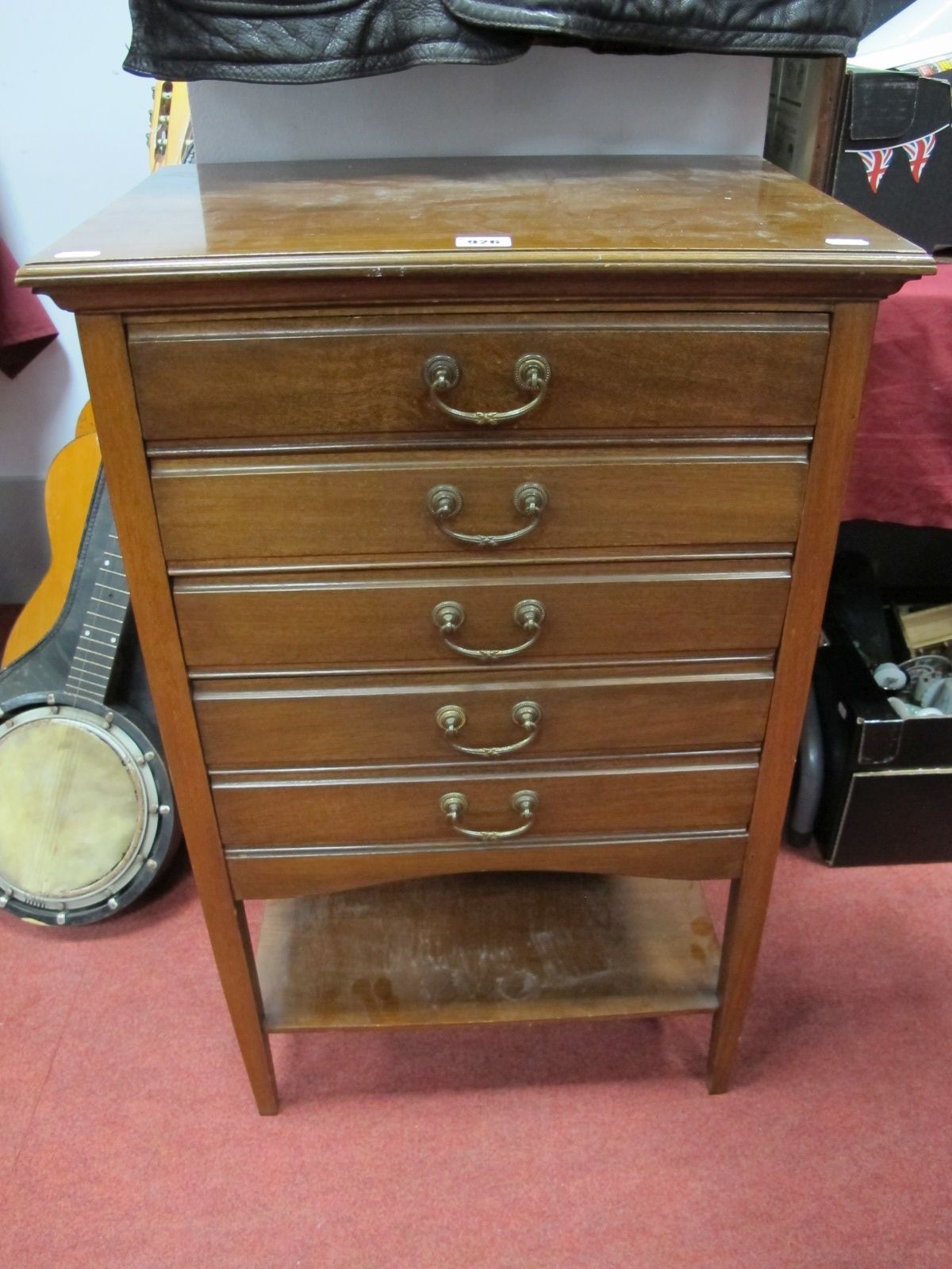 An Early XX century Mahogany Five Drawer Music Cabinet, each with fall front, shaped apron piece