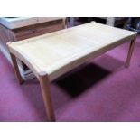 An Ercol Ash Rectangular Shaped Coffee Table, with a panelled top on half round legs.