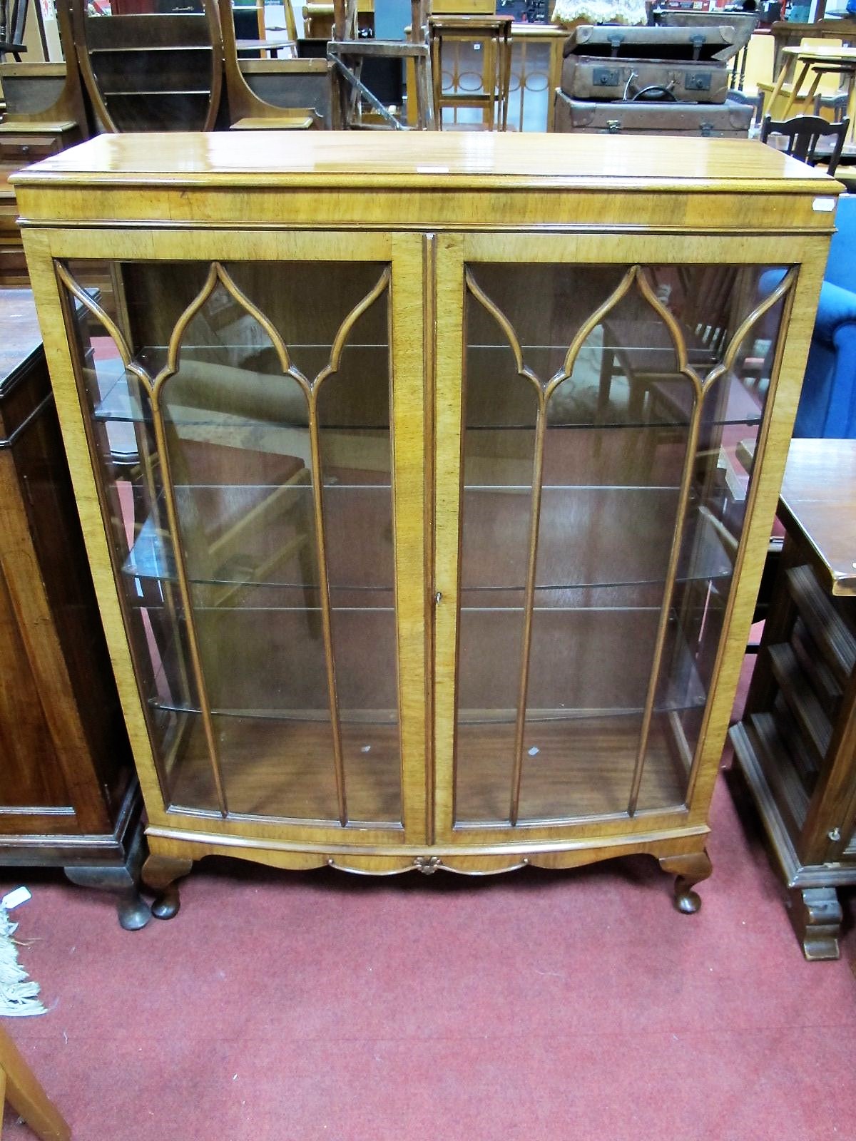 A 1920's Mahogany Bowfronted Display Cabinet, astragal glazed doors with interior glass shelving, on