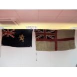 A Royal Navy White Ensign, 87 x 170cm, and a blue ensign with golden lion, 75cm by 130cm.