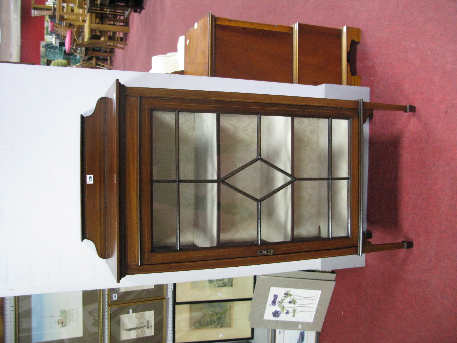 An Edwardian Inlaid Mahogany Display Cabinet, with a shaped low back, glazed astragal door, two