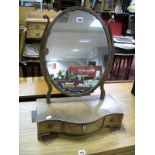 A Mahogany Oval Dressing Mirror, on 'S' supports and serpentine three drawer base, having