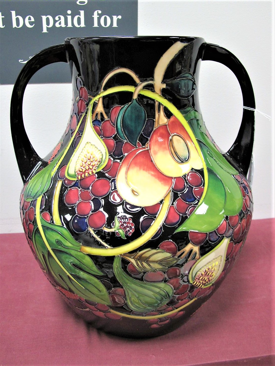 A Moorcroft Prestige Pottery Twin Handled Vase, decorated in the Queens Choice design by Emma