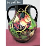 A Moorcroft Prestige Pottery Twin Handled Vase, decorated in the Queens Choice design by Emma