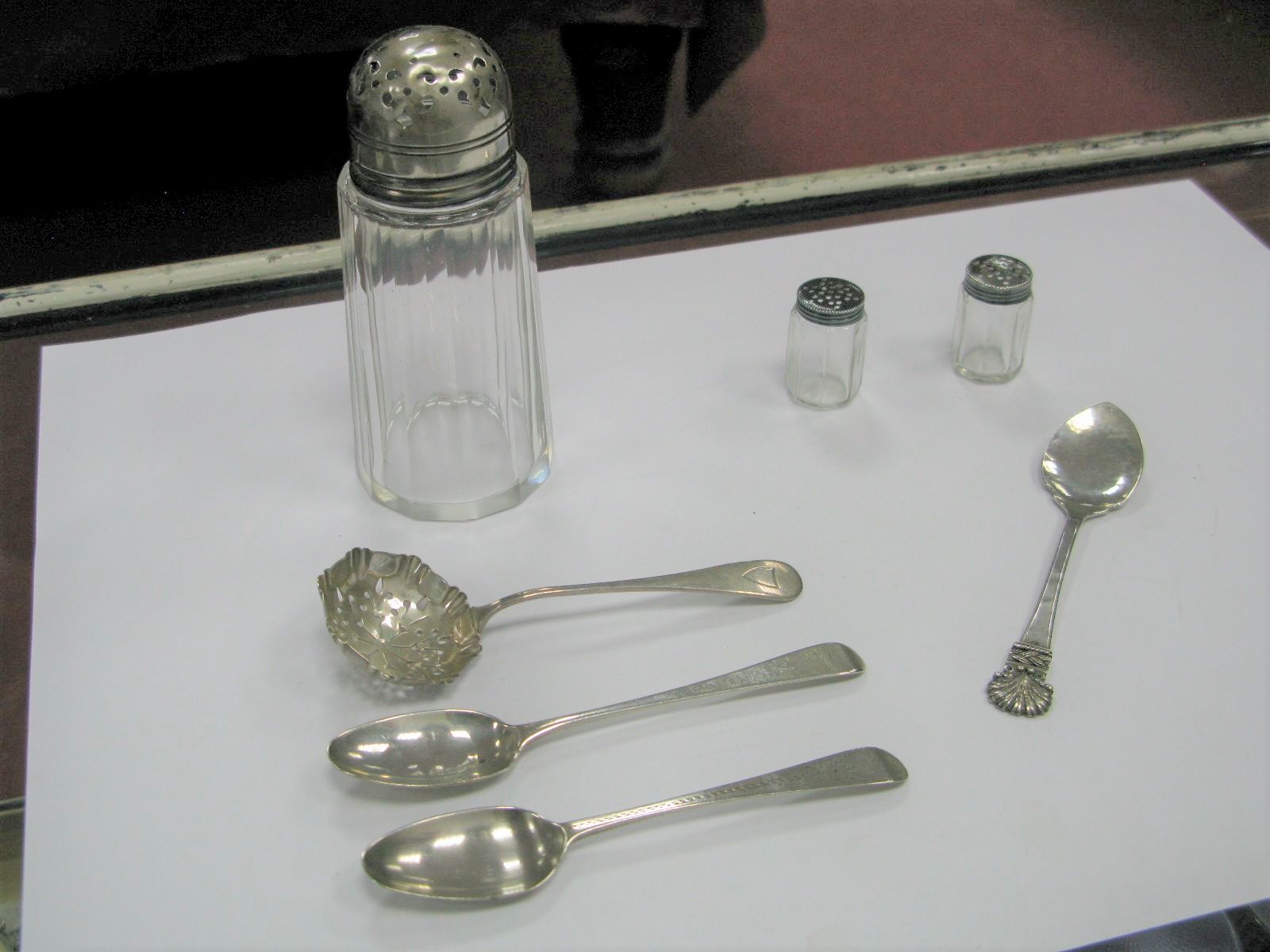 A Hallmarked Silver Topped Glass Sugar Shaker; together with a pair of miniature shakers and three