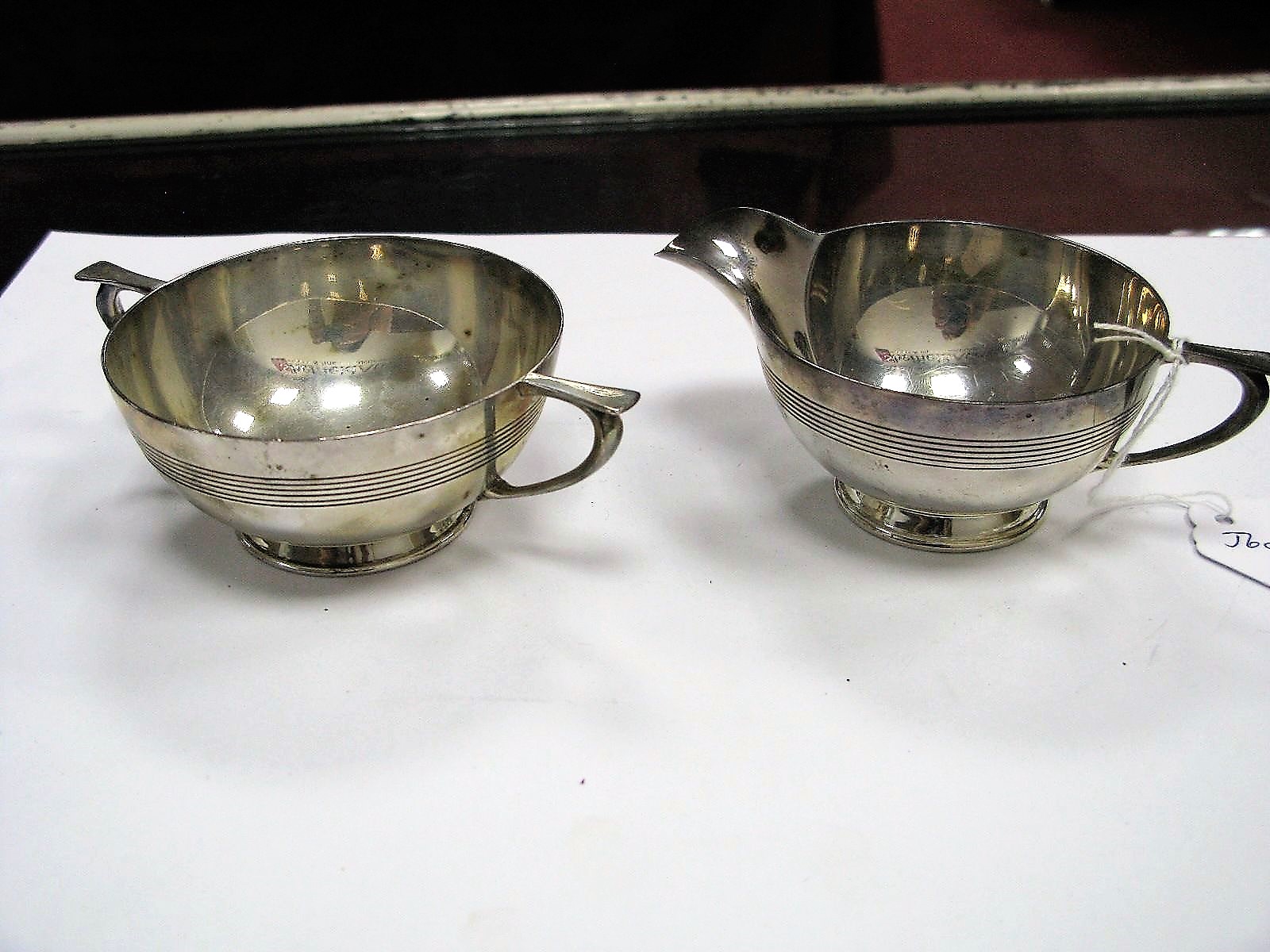 A Matched Hallmarked Silver Jug and Sugar Bowl, each of shallow circular form with reeded detail. (